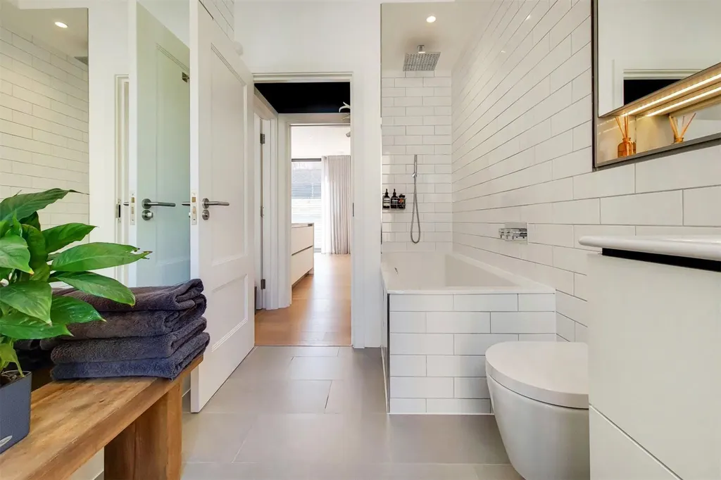 Bathroom with full-size bath, shower and wall-hung toilet