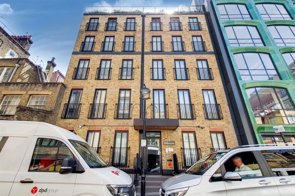 Brick facade of 12-13 Richmond Buildings on a quiet Soho street